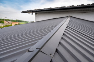 A close-up image of a black standing seam metal roof on a home in Georgia.